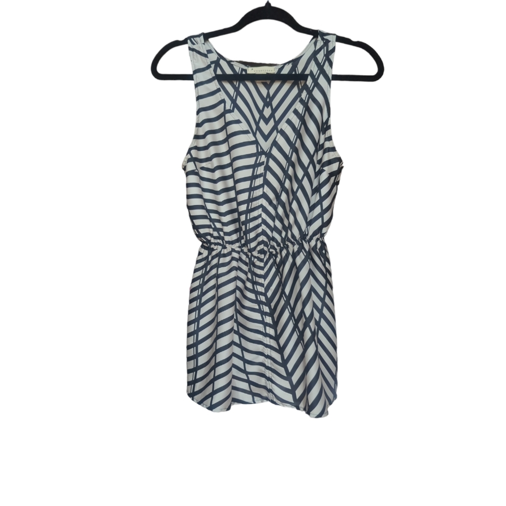 Small cream and black sleeveless top.